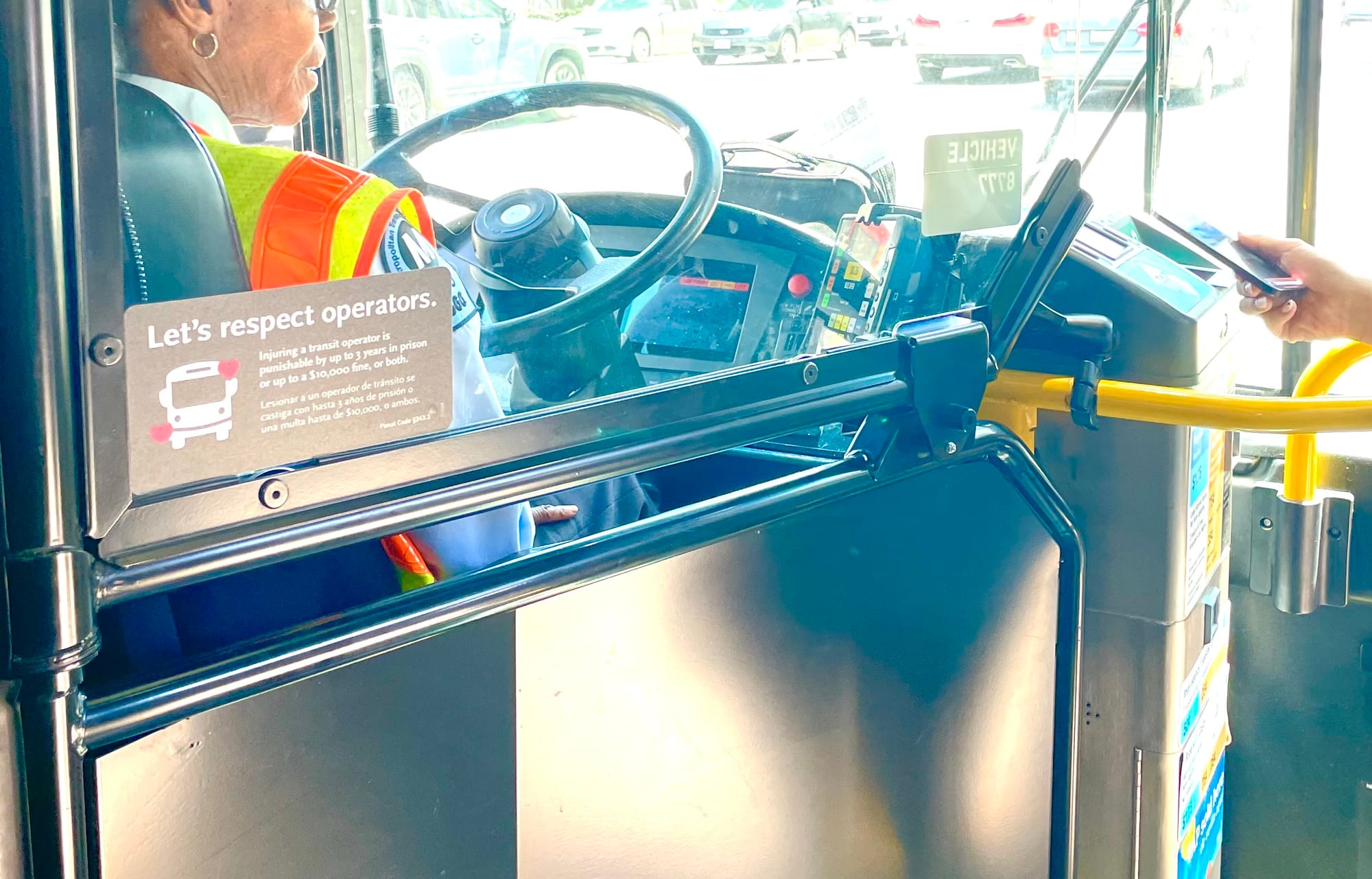 A Metro bus showing a protective plexiglas barrier that stops just short of the farebox