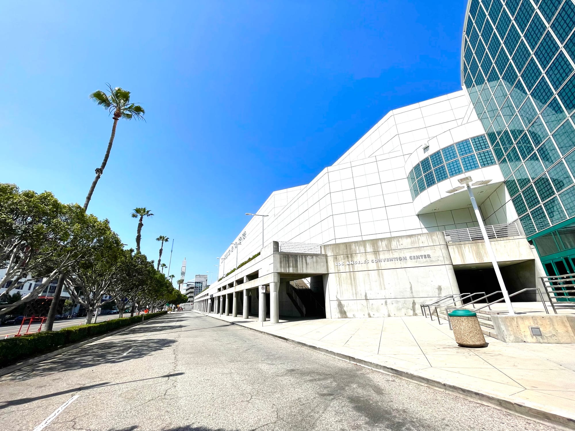 Another pretty desolate view of the convention center with white tiles and fake glass block and a wide service road