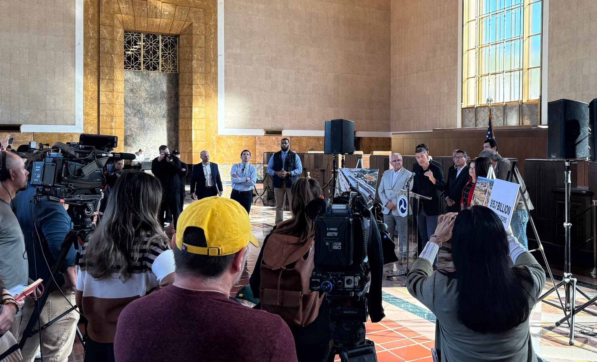 The press conference in Union station showing Sean Duffy speaking behind a podium with other leaders