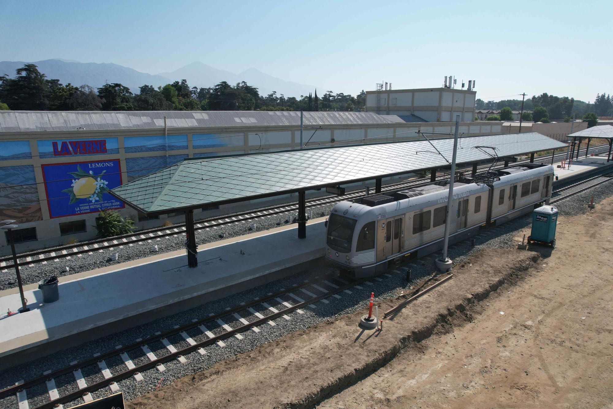 The new A line La Verne/Fairplex station under construction showing a light rail train pulling through the platform