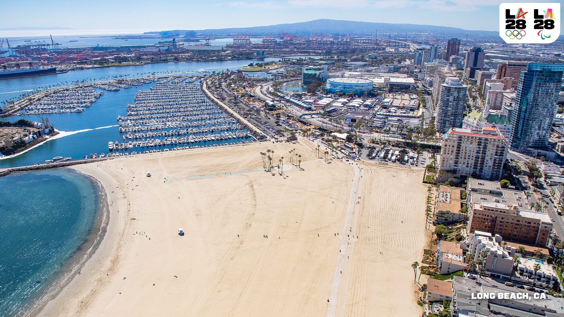 LA28's rendering of Long Beach showing a wide sandy beach, lots of boats in the marina and the downtown skyscrapers