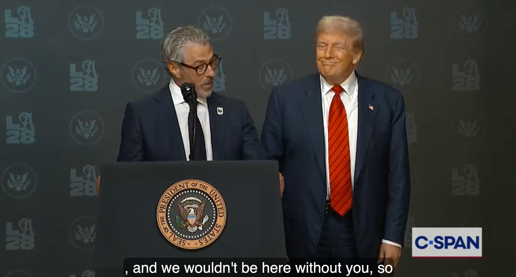 LA28 chair Casey Wasserman and Donald Trump are at a press conference standing at a presidential podium at an LA28 press conference