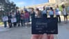 Elected officials lined up for a press conference with a TAP card being held in the front that reads SoCal Transit Week