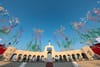 The arches of the Coliseum in Expo Park with colorful smoke "fireworks" exploding into the sky during the day