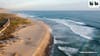 A LA28 rendering for Trestles Beach showing a wide sandy surf break and a train