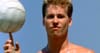 Val Kilmer as Iceman in the iconic beach volleyball scene from Top Gun spinning a volleyball on his finger
