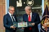 LA28 chair Casey Wasserman presents Donald Trump with medals from the 1984 games at a White House press conference